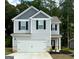 Charming two-story home featuring a gray siding, black shutters, and a spacious white garage door at 431 Prescott Way, Villa Rica, GA 30180