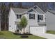 Charming two-story home with a gray exterior, white trim, black shutters, landscaping, and a two-car garage at 431 Prescott Way, Villa Rica, GA 30180
