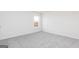 Neutral carpet and window highlight this bright bedroom, ready for your personal touch at 438 Prescott Way, Villa Rica, GA 30180
