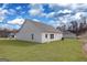 Spacious backyard with level lawn and white siding on home exterior, offering potential for outdoor activities at 442 Prescott Way, Villa Rica, GA 30180