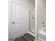Modern bathroom with shower, bathtub, and white door on the left at 442 Prescott Way, Villa Rica, GA 30180