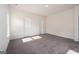A bright bedroom with carpet, white walls, two doors, and a double window at 442 Prescott Way, Villa Rica, GA 30180
