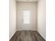 Entryway showcasing a white door with glass panels and dark wood floors, creating an inviting transition space at 442 Prescott Way, Villa Rica, GA 30180