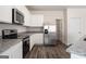 Bright kitchen features stainless steel appliances, white cabinets, and granite countertops at 442 Prescott Way, Villa Rica, GA 30180