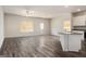 Bright living space featuring sleek flooring, a ceiling fan, and abundant natural light from well-placed windows at 442 Prescott Way, Villa Rica, GA 30180