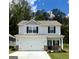 Charming two-story home featuring a spacious garage, black accents, and a well-manicured lawn at 449 Prescott Way, Villa Rica, GA 30180