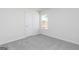 Comfortable bedroom with neutral carpet, a window view, and a door at 467 Prescott Way, Villa Rica, GA 30180