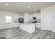 Well-lit kitchen with a large island, granite countertops, white cabinets, and stainless steel appliances at 467 Prescott Way, Villa Rica, GA 30180