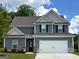 Charming two-story home featuring a gray exterior, attached two-car garage, and well-manicured lawn at 425 Prescott Way, Villa Rica, GA 30180