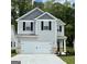 Charming two-story home boasts a modern facade, a spacious garage, and manicured landscaping at 439 Prescott Way, Villa Rica, GA 30180