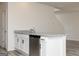 Kitchen island with stainless steel dishwasher, granite counters, and white cabinets at 439 Prescott Way, Villa Rica, GA 30180