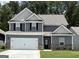 Two-story home featuring gray siding, white trim, black shutters and a two car garage at 443 Prescott Way, Villa Rica, GA 30180