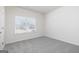 Bedroom with carpet flooring and a large window overlooking the exterior at 445 Prescott Way, Villa Rica, GA 30180