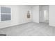 Bright bedroom with neutral carpet, large window, and a doorway leading to another room at 445 Prescott Way, Villa Rica, GA 30180