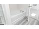 Bathroom featuring a garden tub, wood-look flooring, and white walls at 448 Prescott Way, Villa Rica, GA 30180