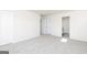 Neutral bedroom featuring a double-door closet and a standard closet with neutral carpet at 448 Prescott Way, Villa Rica, GA 30180