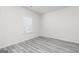 Bright bedroom with a window offers natural light and features wood-look flooring at 448 Prescott Way, Villa Rica, GA 30180