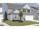 Charming two-story house showcases gray siding, a two-car garage, and a lush green lawn at 448 Prescott Way, Villa Rica, GA 30180