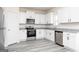 Modern kitchen boasts stainless steel appliances, white cabinets, and granite countertops at 448 Prescott Way, Villa Rica, GA 30180