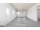 Bright open living room showcases light gray wood floors, multiple windows, and neutral paint at 448 Prescott Way, Villa Rica, GA 30180