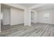 Spacious living room featuring light gray wood floors, neutral paint, and large windows at 448 Prescott Way, Villa Rica, GA 30180