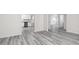 Open-concept living area showcasing light gray flooring and access to the kitchen and dining spaces at 448 Prescott Way, Villa Rica, GA 30180
