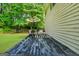 View of home's back deck with outdoor furniture, a trampoline, and a lush green lawn at 242 Greenland Dr, Mcdonough, GA 30253