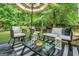 Cozy outdoor seating area featuring an umbrella, stylish furniture, and decorative lanterns on the deck at 242 Greenland Dr, Mcdonough, GA 30253