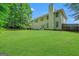Wide view of a large backyard with deck, trampoline, and mature trees, perfect for outdoor activities at 242 Greenland Dr, Mcdonough, GA 30253