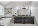 Bathroom featuring a double sink vanity, a soaking tub and a window offering natural light at 242 Greenland Dr, Mcdonough, GA 30253