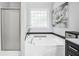 Bright bathroom featuring a soaking tub with shower, modern finishes, and natural light at 242 Greenland Dr, Mcdonough, GA 30253