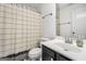 Well-lit bathroom featuring a vanity, mirror, toilet, and shower with a striped curtain at 242 Greenland Dr, Mcdonough, GA 30253