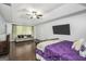 Spacious bedroom featuring trey ceilings, hardwood floors, and a sitting area with sofa at 242 Greenland Dr, Mcdonough, GA 30253