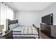 Bedroom with wood floors, TV, neutral wall paint, and bright window at 242 Greenland Dr, Mcdonough, GA 30253