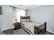 Bedroom with wood floors, neutral wall paint, bedside table, and bright window at 242 Greenland Dr, Mcdonough, GA 30253
