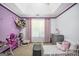 Charming ' bedroom with purple accents, playful decor, and plenty of toy storage at 242 Greenland Dr, Mcdonough, GA 30253