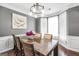 Formal dining room with gray walls, white trim, hardwood floors, and chandelier lighting at 242 Greenland Dr, Mcdonough, GA 30253