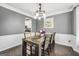 Dining room featuring gray walls, a dark wood table with seating for six, and a decorative flower centerpiece at 242 Greenland Dr, Mcdonough, GA 30253