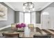 Dining room with a dark wood table, modern chandelier, and bay window at 242 Greenland Dr, Mcdonough, GA 30253
