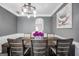 Dining room with a long wood table, comfortable seating, and modern decor under a stylish chandelier at 242 Greenland Dr, Mcdonough, GA 30253