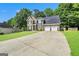 Two-story brick home featuring a two-car garage, ample driveway, and a beautifully maintained green lawn at 242 Greenland Dr, Mcdonough, GA 30253