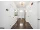 Bright hallway with multiple doors, arched entryways, and hardwood flooring at 242 Greenland Dr, Mcdonough, GA 30253