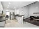 Open-concept kitchen includes white cabinets, stainless steel appliances, and breakfast bar seating at 242 Greenland Dr, Mcdonough, GA 30253