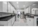 Spacious kitchen featuring white cabinetry, stainless steel appliances, and tiled flooring at 242 Greenland Dr, Mcdonough, GA 30253