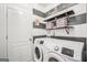 Modern laundry room with a new white front-loading Samsung washer and dryer set at 242 Greenland Dr, Mcdonough, GA 30253