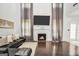 Inviting living room featuring a fireplace, large windows, and a comfortable sofa at 242 Greenland Dr, Mcdonough, GA 30253