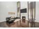 Comfortable living room featuring a fireplace, high ceilings, and elegant decor at 242 Greenland Dr, Mcdonough, GA 30253