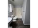 Bathroom featuring a bathtub, a toilet, and a white cabinet at 2353 Wellington Cir, Lithonia, GA 30058