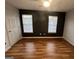Bedroom featuring hardwood floors, light fixtures, and two large windows at 2353 Wellington Cir, Lithonia, GA 30058