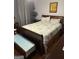 Bedroom featuring a large wooden bed frame, blue floral bedding, and decorative art at 2353 Wellington Cir, Lithonia, GA 30058